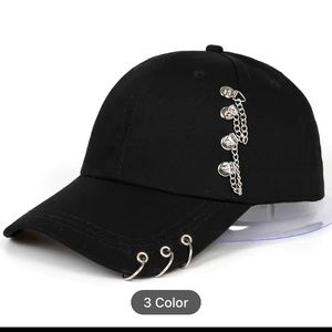 Black ball cap with pierced rings and chain details